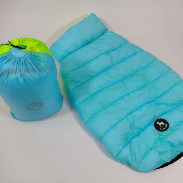 The new Dog A La Mode light blue weatherproof reversible dog puffer jacket back view with a bag