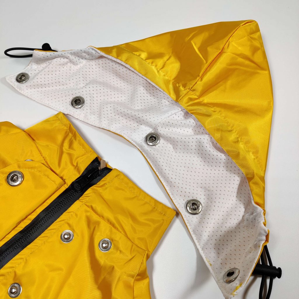 Close up of the new Dog A La Mode yellow waterproof dog Buddy raincoat with a buttoned detachable hood