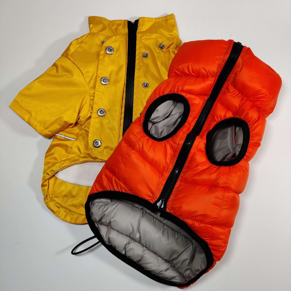 The new Dog A La Mode Outdoor Jacket Collection including the fully waterproof yellow dog Buddy raincoat with a detachable hood and the reversible orange dog puffer jacket