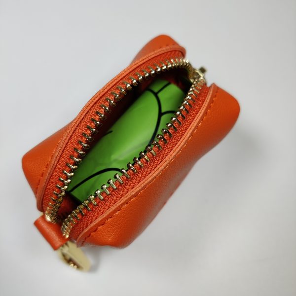 Dog A La Mode Le Classique orange dog poop bags holder front view made out of high quality vegan leather opened with fully biodegradable dog poop bags inside