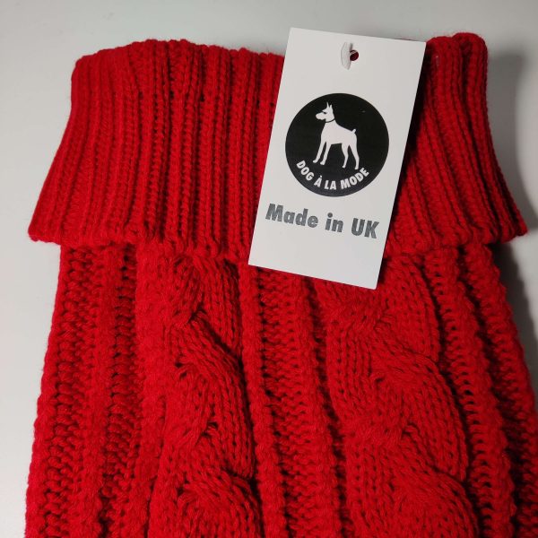 Dog A La Mode cable knitted and thick British manufactured red classic dog jumper with a made in UK tag with the Dog A La Mode logo in the front close up view